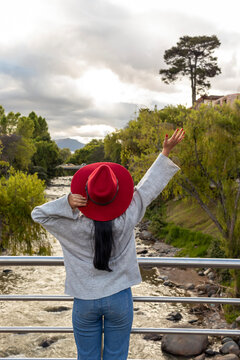 Tourist enjoying the view of tomebamba river in cuenca, ecuador