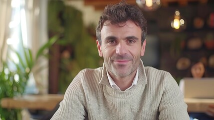 Mature hispanic businessman engaged in online training and video calls from his office space