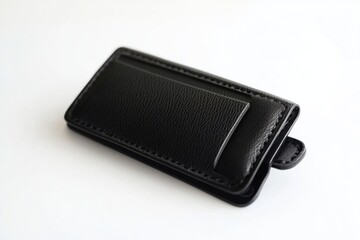 A single black leather wallet lying on a white surface