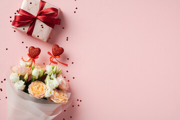 Gift box with red ribbon and bouquet of flowers with heart decorations on pink background. Perfect for Valentine's Day, anniversaries, or romantic celebrations