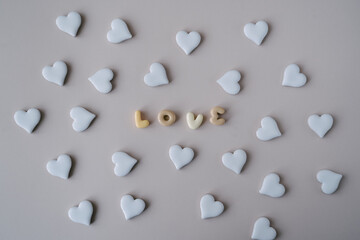 An arrangement of white ceramic hearts surrounding the word 