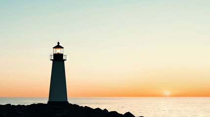   A lighthouse sits atop a rocky seashore, with the ocean as its neighbor and the setting sun as its backdrop