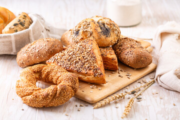 Variation of bread rolls or buns with butter and assorted seeds with breadbag