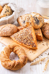 Variation of bread rolls or buns with butter and assorted seeds with breadbag