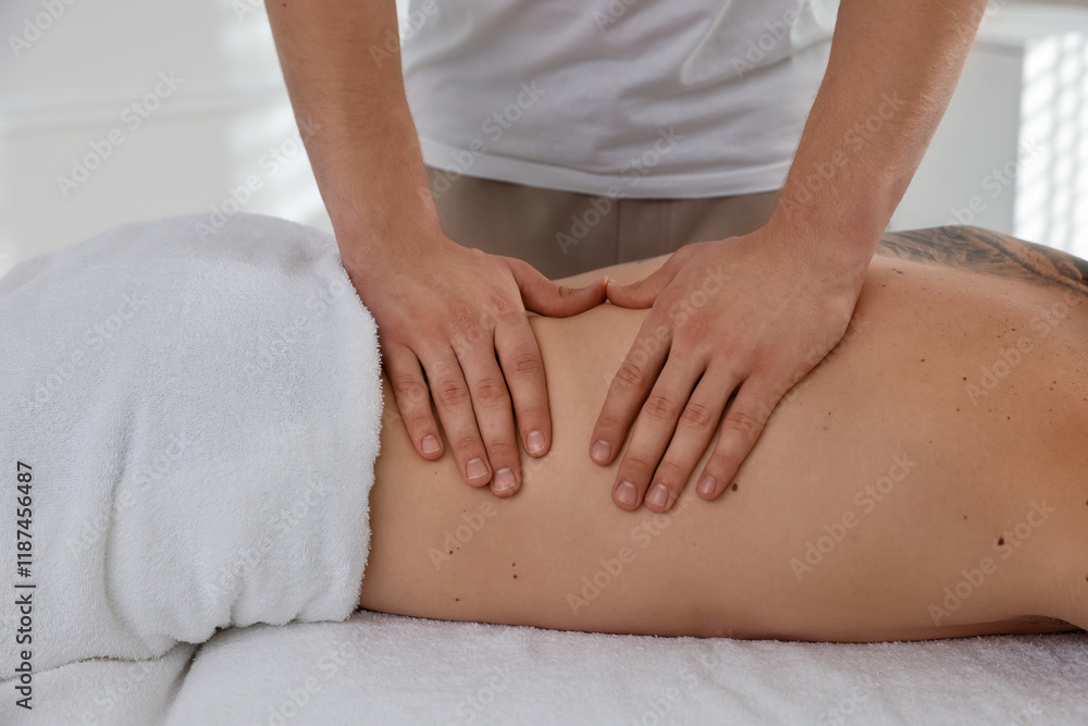 Wall mural Massage therapist working with patient in clinic, closeup