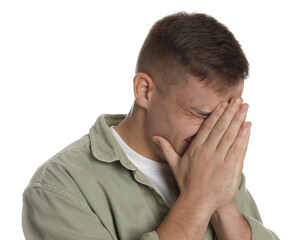 Distressed young man crying on white background