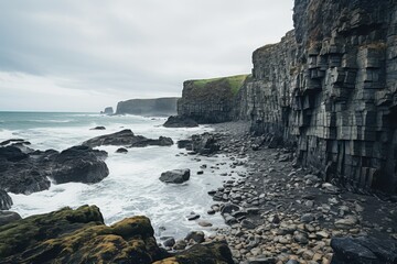 Rocky coastline with wave splashes and cloudy sky along a rugged shore in an outdoor environment