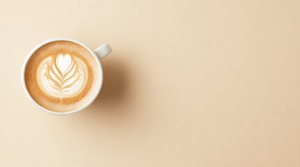   A beige background showcases a cup of cappuccino with a leaf design on top