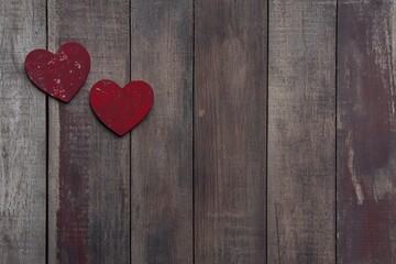Valentines' day background with two red hearts on wooden background 