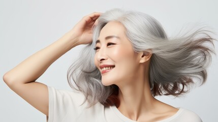 Obraz premium Senior Asian woman smiles brightly, showcasing her happiness in a captivating portrait. Perfect for uplifting content