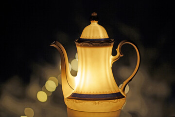 Light object, porcelain coffee pot in the night.