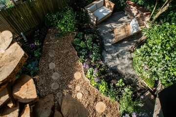 Backyard Garden with Raised Wooden Beds: A suburban garden with raised beds planted with a mix of vegetables and flowers, surrounded by wood chips.