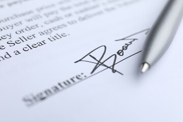 Ballpoint pen and signature on contract, closeup