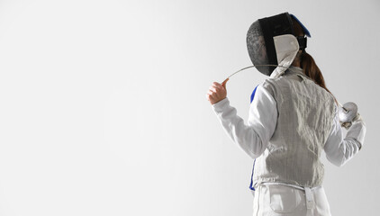 Fencer with epee on white background, space for text