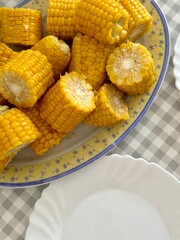 Plate of boiled sweet corn pieces on a table ready to serve
