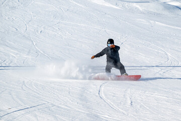 People are having fun in downhill skiing and snowboarding	
