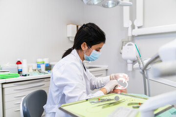 Fototapeta premium Dentist working on patient's teeth in modern dental clinic