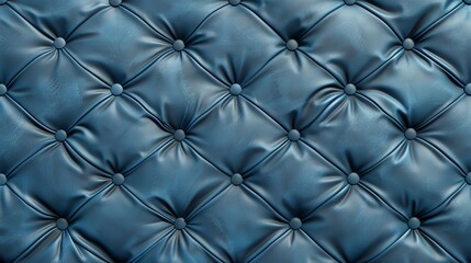 A close-up of a tufted blue leather surface, highlighting the texture and the buttoned design.