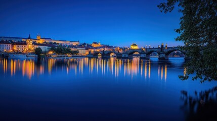 Obraz premium Night cityscape with illuminated bridge reflecting on calm river water.