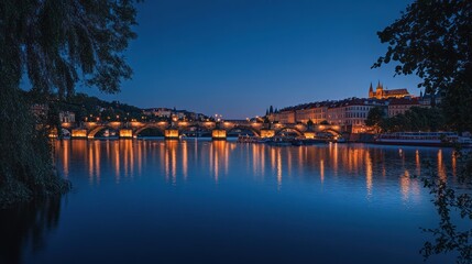 Obraz premium Night view of a city bridge and river with illuminated buildings and reflections.