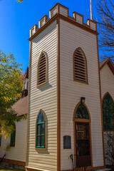 A tall white building with a steeple and arched windows
