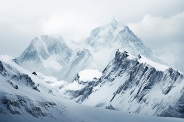 Obraz premium Snow-covered mountain range under a cloudy sky in a remote location during winter season