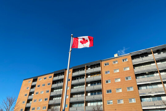 Canadian Flag Flying Near Residential Building