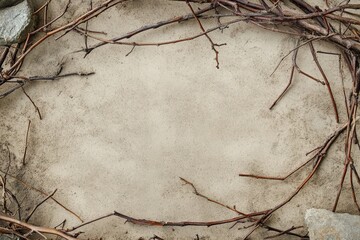 Twigs forming a frame on light sandy ground