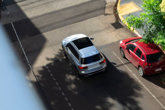 Silver Mercedes Benz GLB cruising city street, Luxury SUV in movement, High angle