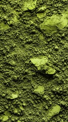 Bright green matcha powder texture with rough clumps and fine granules