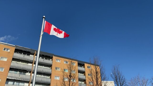 Canadian Flag Flying Near Residential Building