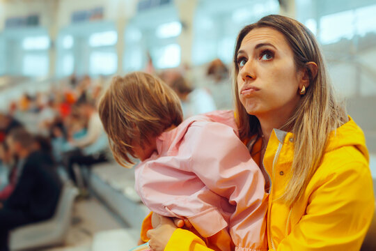 Mother Holding her Hyperactive Daughter at Entertainment Show. Fidgety kid unable to attend a fun event due to short attention span
