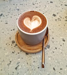 Jakarta, Indonesia - Jan 10, 2025: A cup of hot chocolate with a heart shape of latte art decorating the refreshment drink