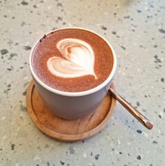 Jakarta, Indonesia - Jan 10, 2025: A cup of hot chocolate with a heart shape of latte art decorating the refreshment drink