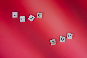 Red hearts and candles on red background with lighting love you letters word text 