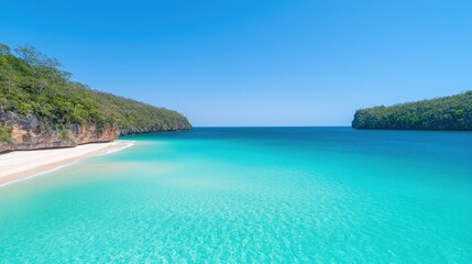 Obraz premium Serene Tropical Beach with Crystal Clear Turquoise Waters Fringed by Lush Green Hills Under a Bright Blue Sky and Gentle Waves Lapping the Shoreline