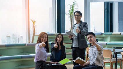 Fototapeta premium A group of Gen Z Asian business consulting, exchanging information in offices, co-working spaces.