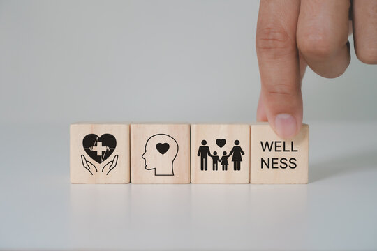 Employee wellness concept. Wooden cube block with health, mindfulness, mental health, happiness, financial stability, growth icon on white background. Balance, integration achieving overall wellbeing.