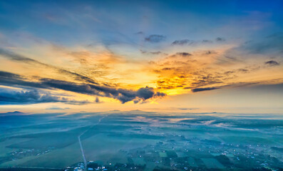 Beautiful sunrise sky above clouds with dramatic light in the suburbs near the future Long Thanh...