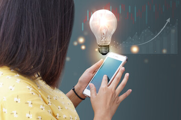 woman hands holding and using a digital device light bulb inspired by innovative business idea, successful startup in concept