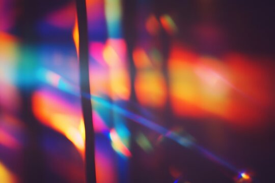 Abstract light leaks, vibrant colors, dark background, studio shot, design element