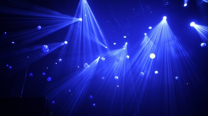intersecting spotlight beams, azure bokeh orbs, midnight blue backdrop, magical light particles, glowing stage ambiance, atmospheric haze, concert venue lighting, dramatic dark environment
