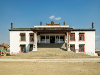 A large building with a red roof and white walls