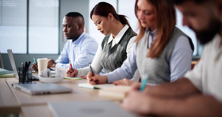 Studying In Classroom At Campus. Students Writing
