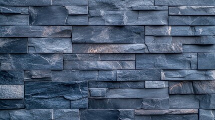 Close-up of dark slate brick wall with textured patterns
