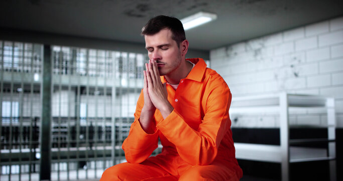 Man Praying To God In Prison Of Jail For Mercy