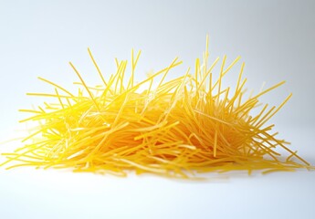 Uncooked Yellow Spaghetti Sticks Piled on a White Background for Culinary and Food Photography Projects Featuring Italian Cuisine and Pasta Dishes