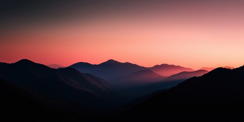Obraz premium A breathtaking sunset casts a serene glow over rolling hills and mountains, creating a peaceful and reflective atmosphere that invites contemplation and appreciation of nature.