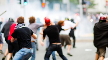 Street Battle Blur – A blurred scene of clashes between protestors and authorities on the street.
