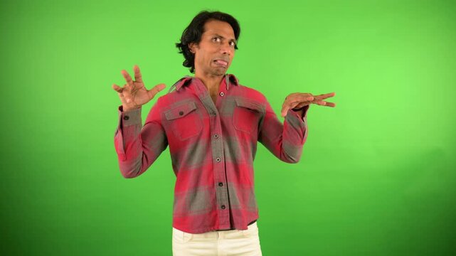 Guy is putting on weird faces mimicking odd emotion